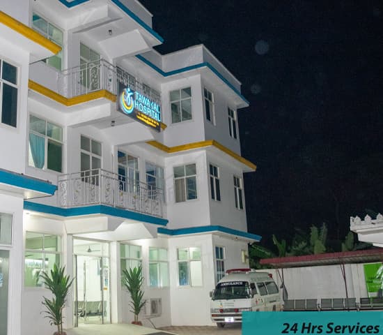 Tawakal Hospital building at night with the ambulance parked outside